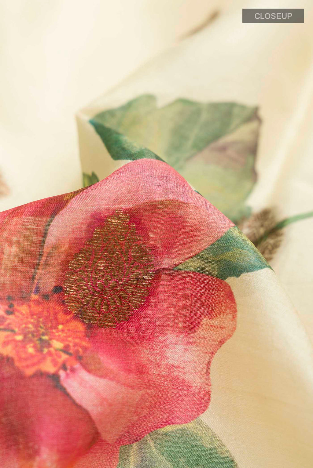 Close up of Yellow Tussar Silk Saree with Printed design on the body and Zari Border displaying folds