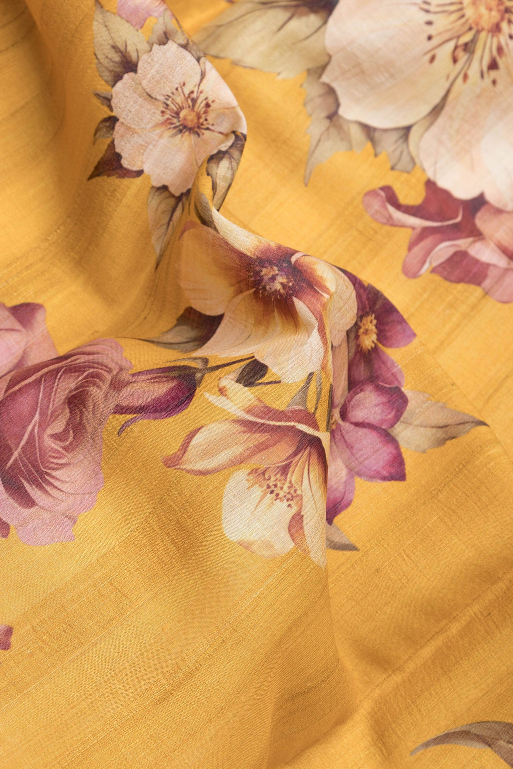 Close up of Yellow Dual Tone Tussar Silk Saree with Printed design on the body and Zari Border.  displaying folds