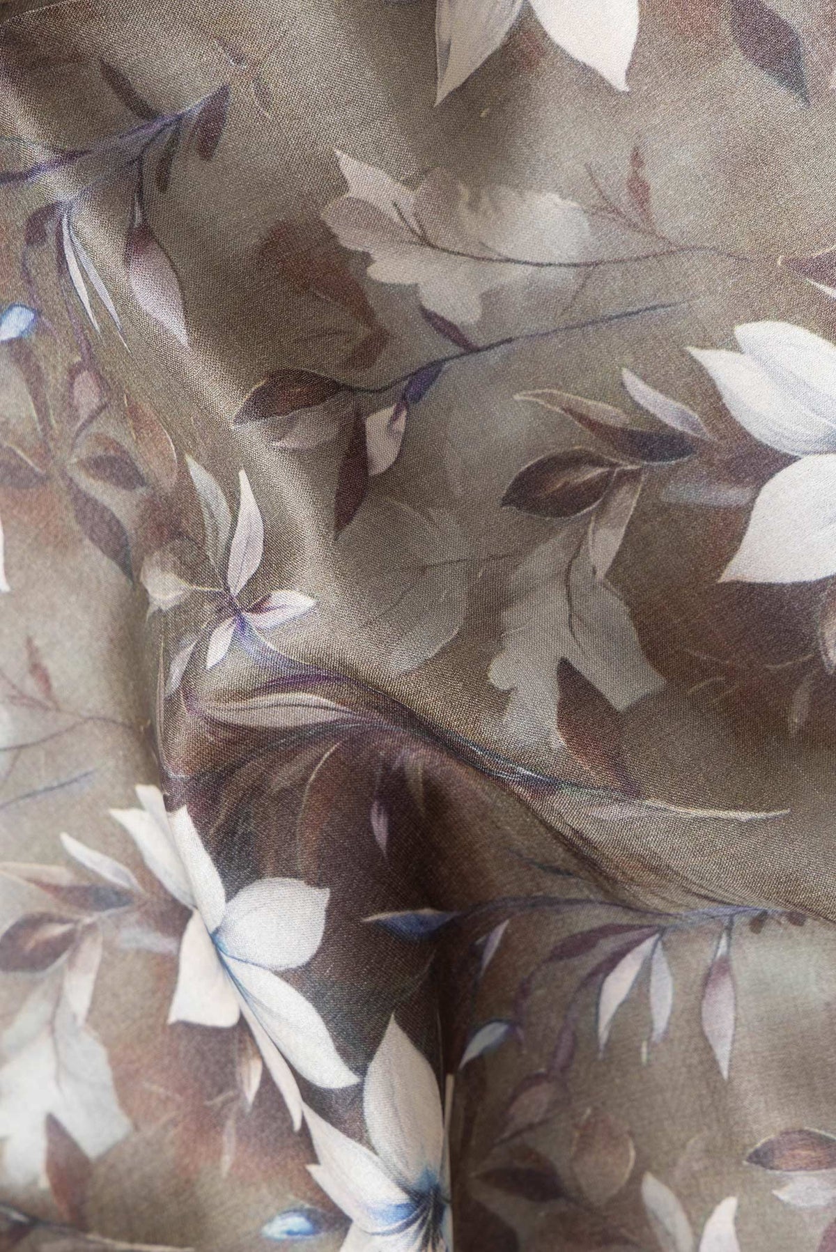 Close up of Mehandi Green Dual Tone Tussar Silk Saree with Printed design on the body and Zari Border.  displaying folds