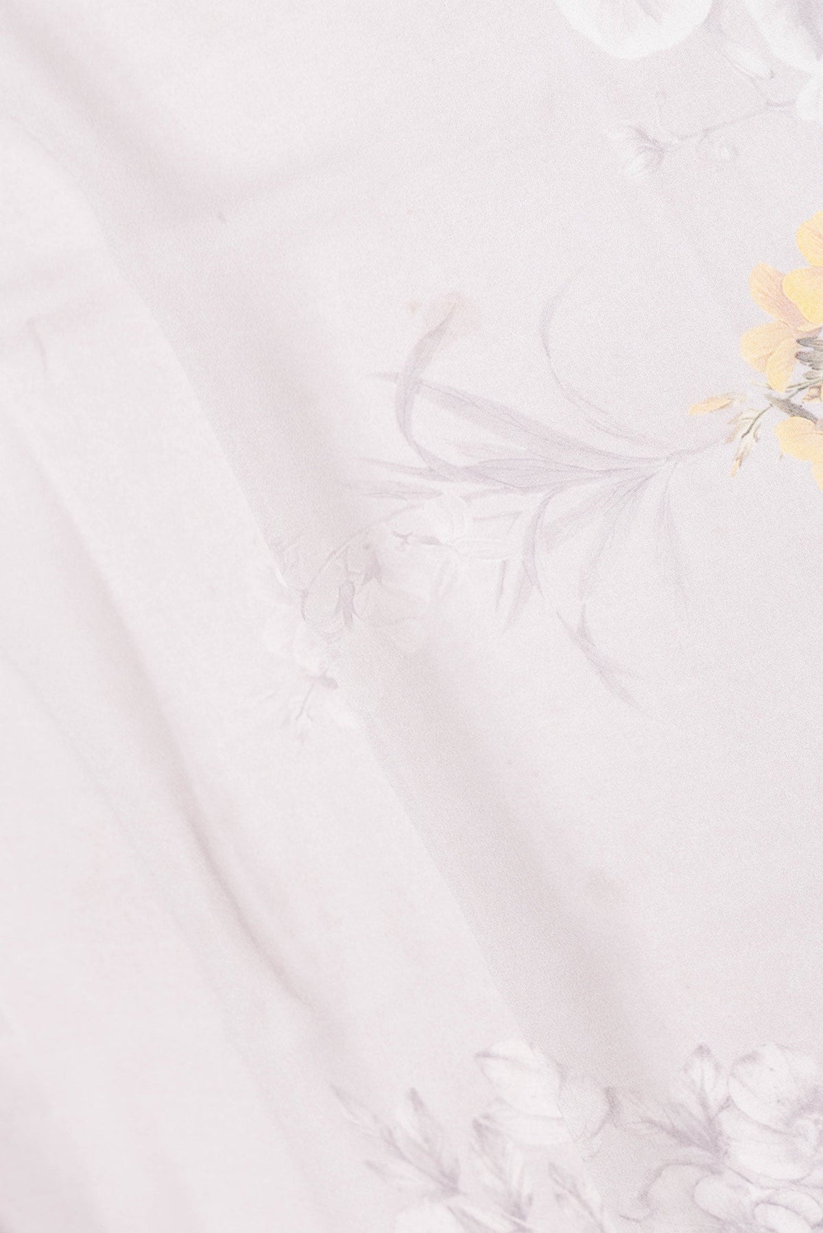 Close up of Grey Dual Tone Mysore Georgette Saree with Printed design on the body and Plain Border displaying folds