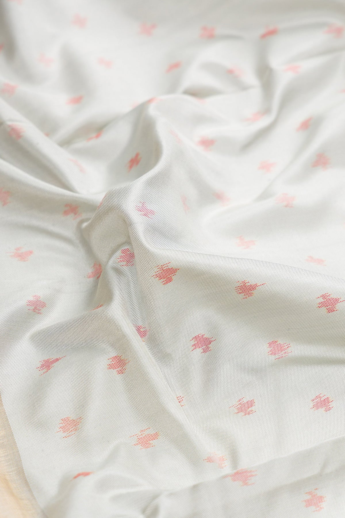 Close up of Grey Dual Tone Kanjivaram Silk Saree with Ikat Print on the body and Ikat Border.  displaying folds