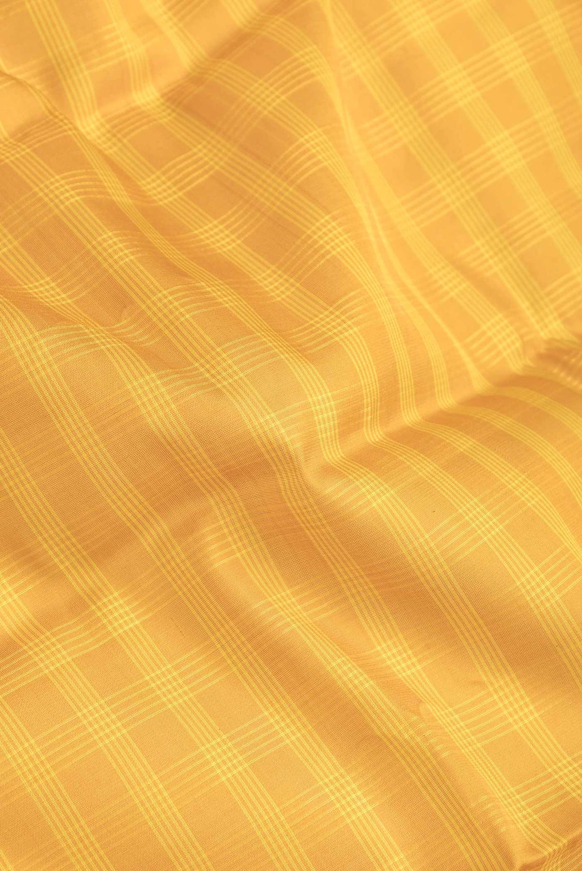 Close up of Yellow Dual Tone Gadwal Silk Saree with Checked design on the body and Zari Border.  displaying folds