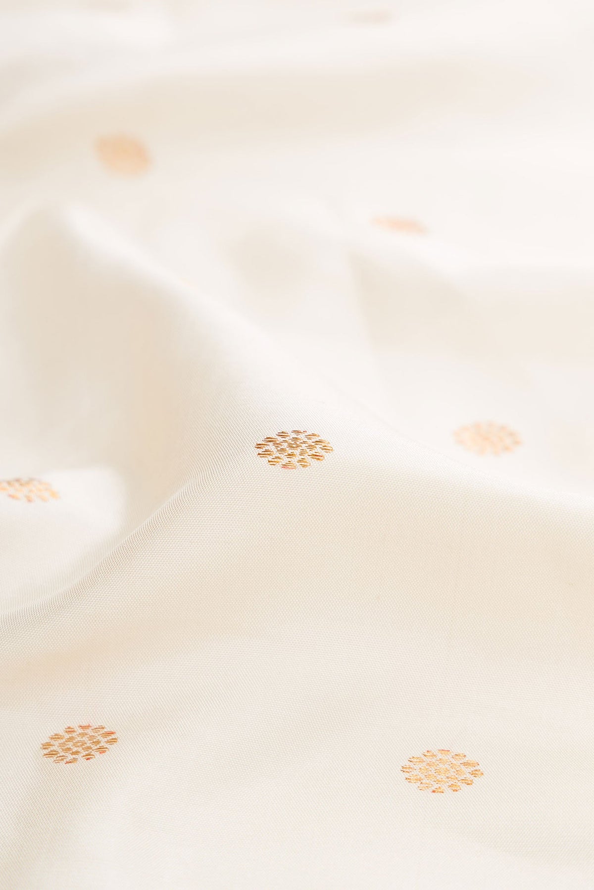 Close up of Off White Dual Tone Gadwal Silk Saree with Zari Butta on the body and Zari Border displaying folds
