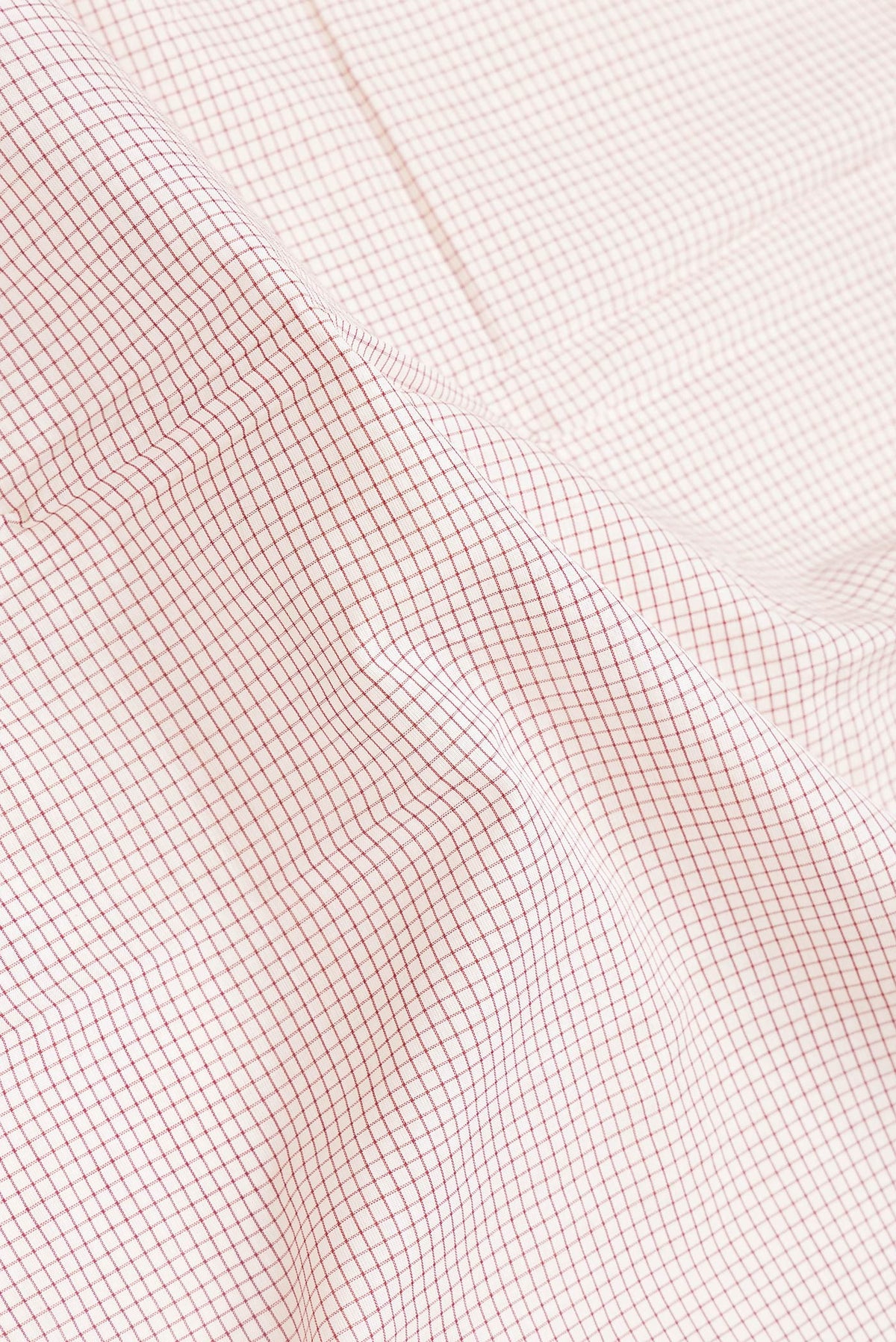 Close up of Off White Dual Tone Double Ikat Saree with Checked design on the body and Ganga Jamuna Border.  displaying folds