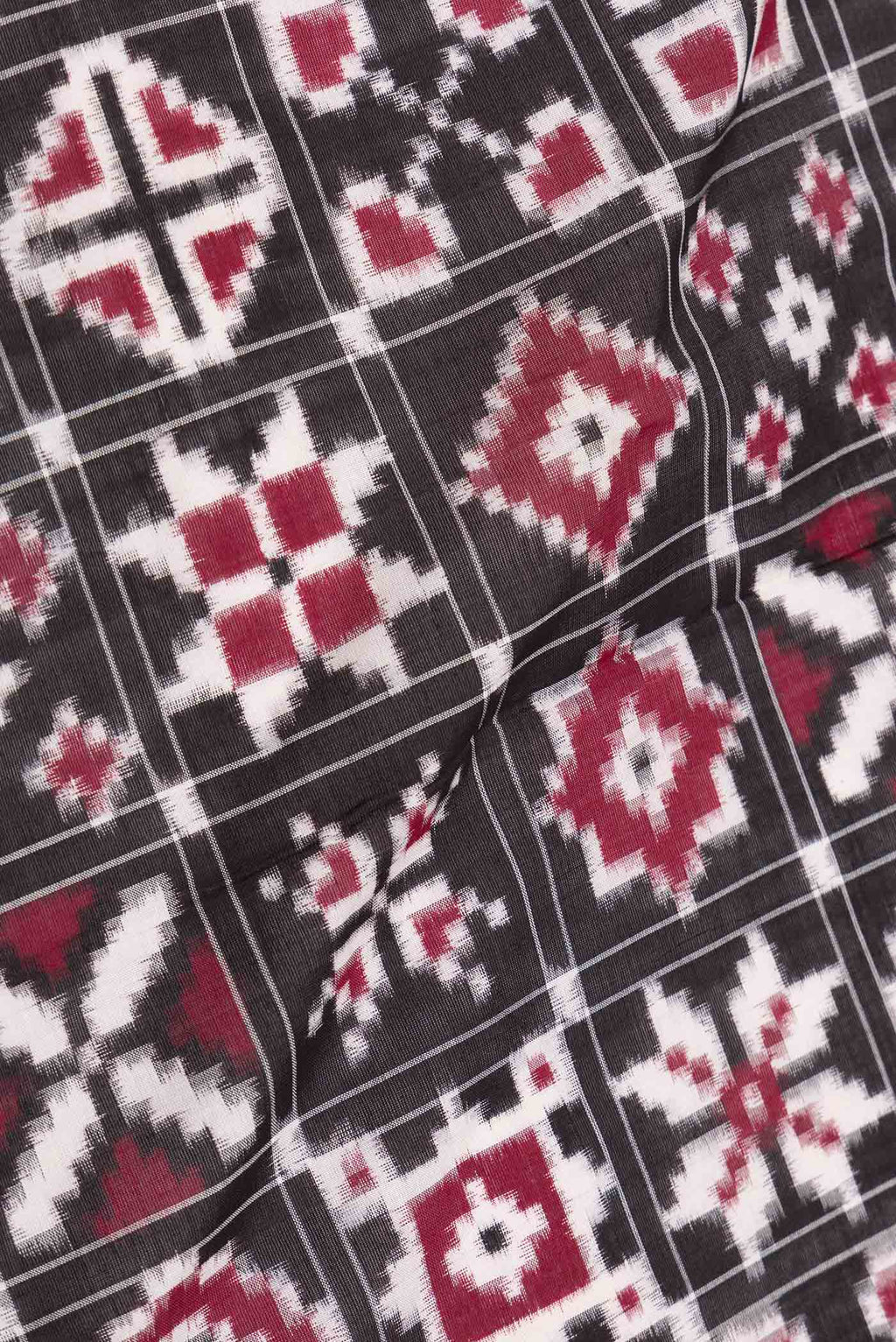 Close up of Black Dual Tone Double Ikat Saree with Ikat Print on the body and Plain Border displaying folds