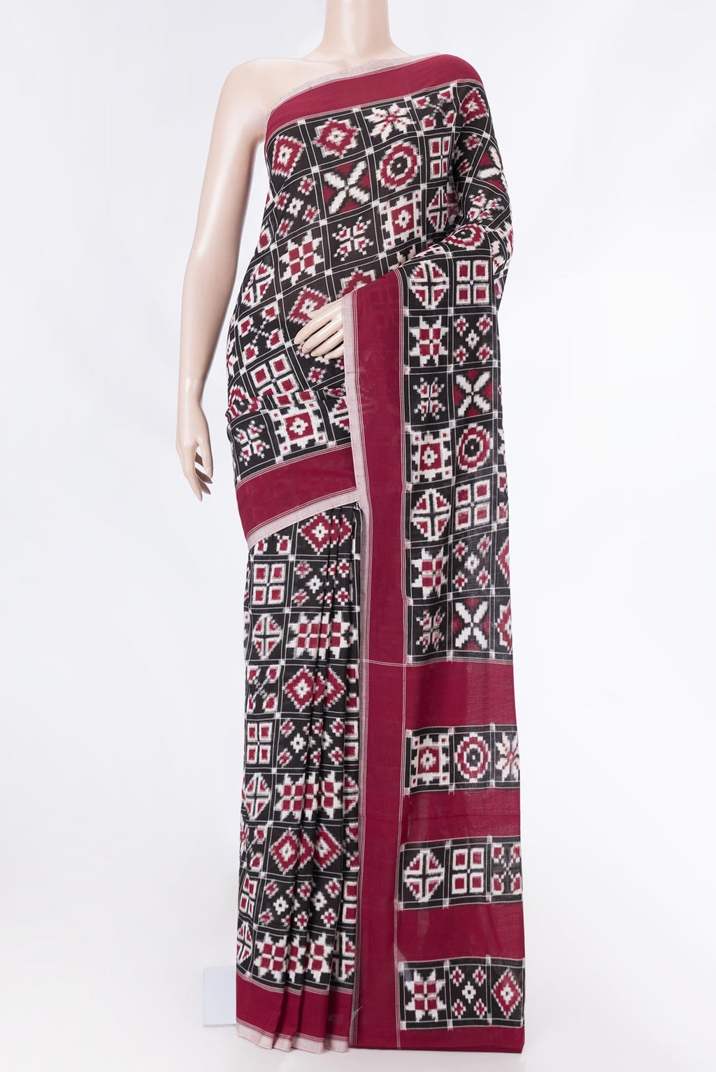 Black Dual Tone Double Ikat Saree with Ikat Print on the body and Plain Border displayed on a mannequin