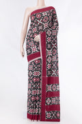 Black Dual Tone Double Ikat Saree with Ikat Print on the body and Plain Border displayed on a mannequin