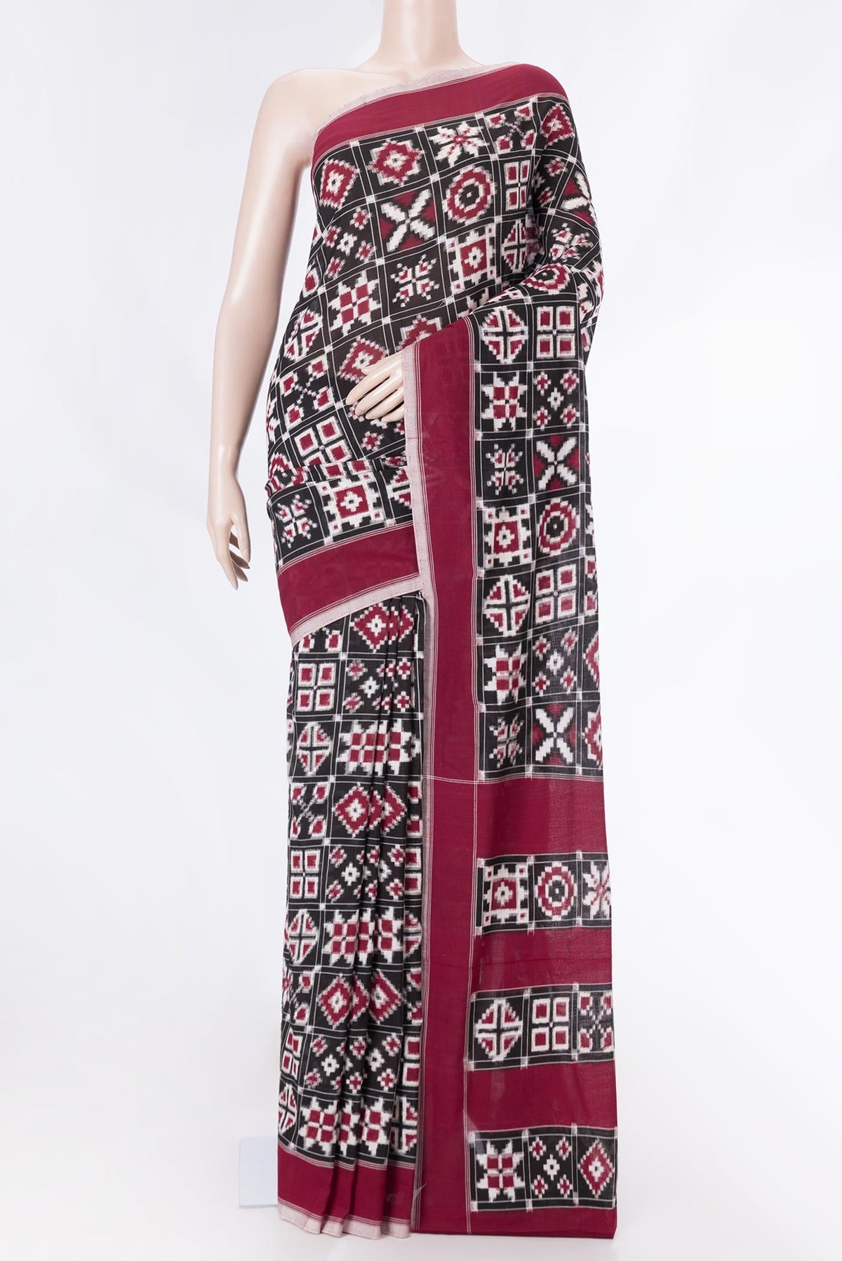 Black Dual Tone Double Ikat Saree with Ikat Print on the body and Plain Border displayed on a mannequin