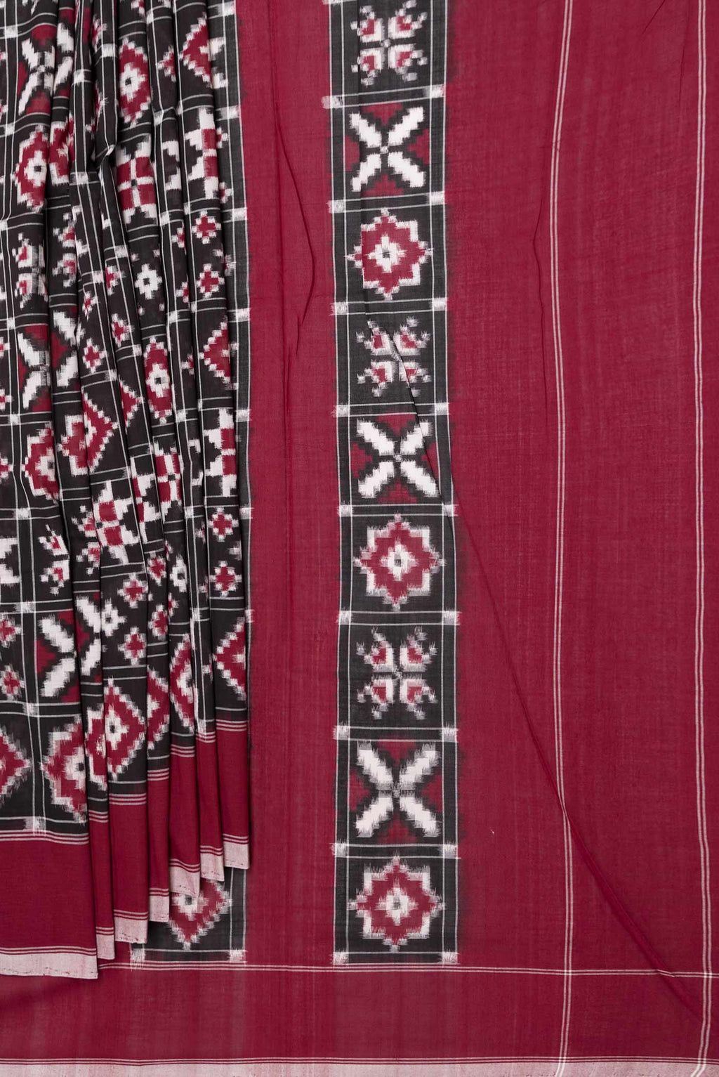 Pleats and pallu of Black Dual Tone Double Ikat Saree with Ikat Print on the body and Plain Border