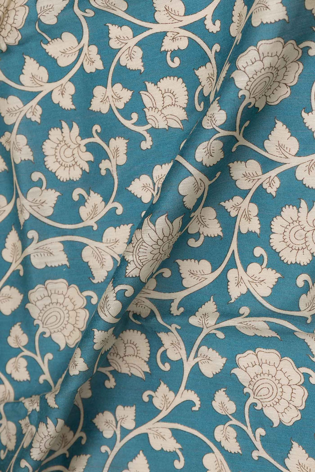Close up of Blue Dual Tone Tussar Saree with Printed design on the body and Zari Border displaying folds
