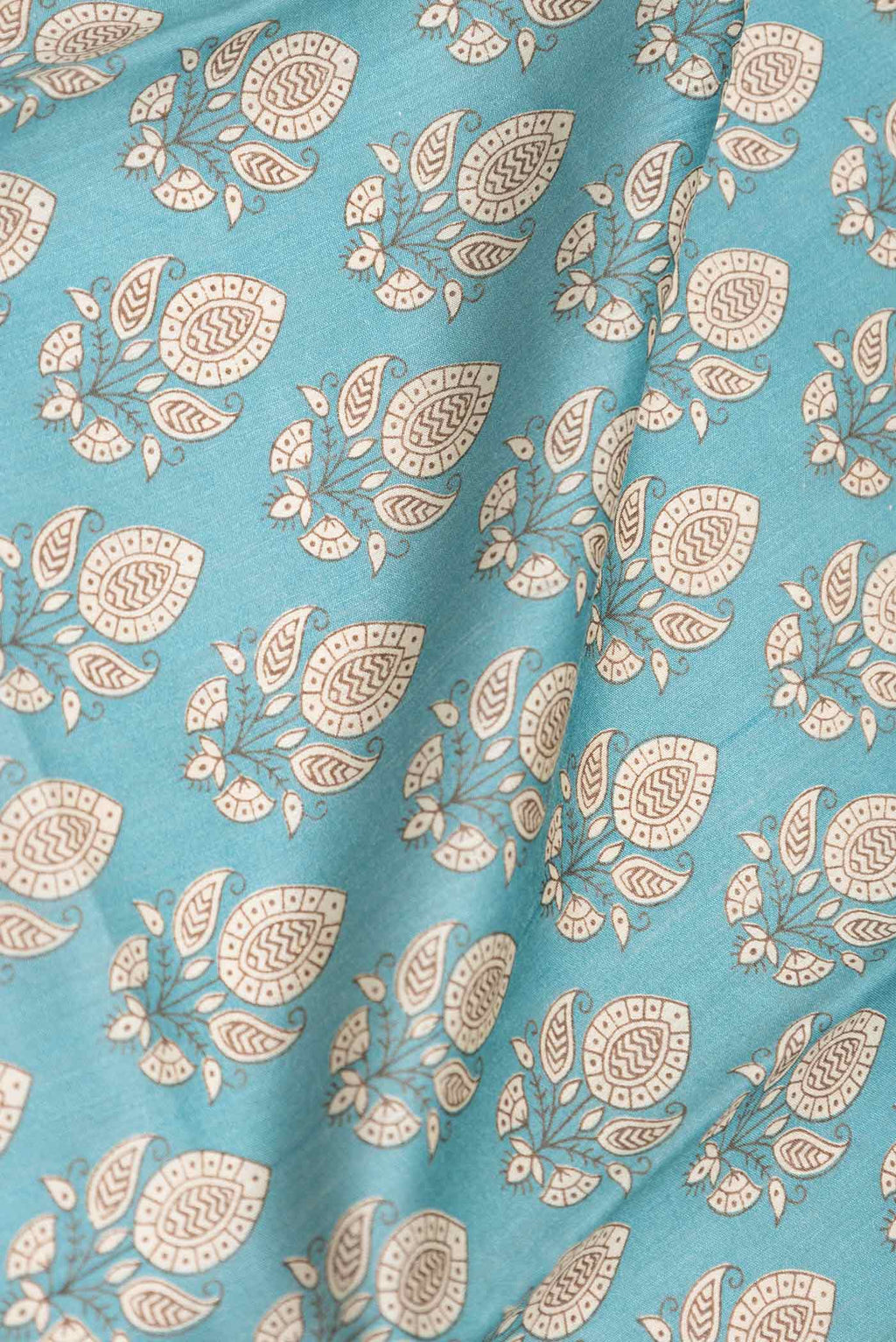 Close up of Sea Green Dual Tone Tussar Silk Saree with Printed design on the body and Zari Border displaying folds