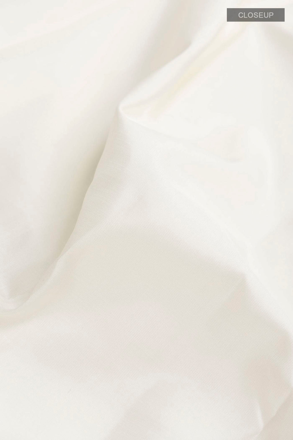 Close up of White Kanchipuram Silk Saree with Plain Body and Checks Border displaying folds