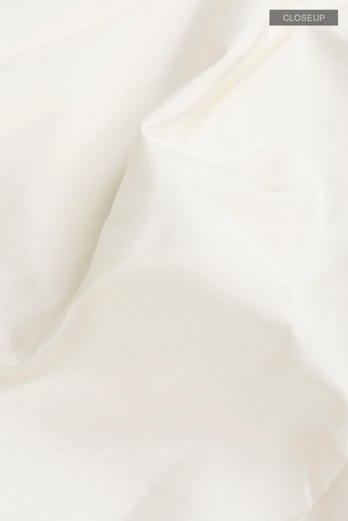 Close up of White Kanchipuram Silk Saree with Plain Body and Checks Border displaying folds