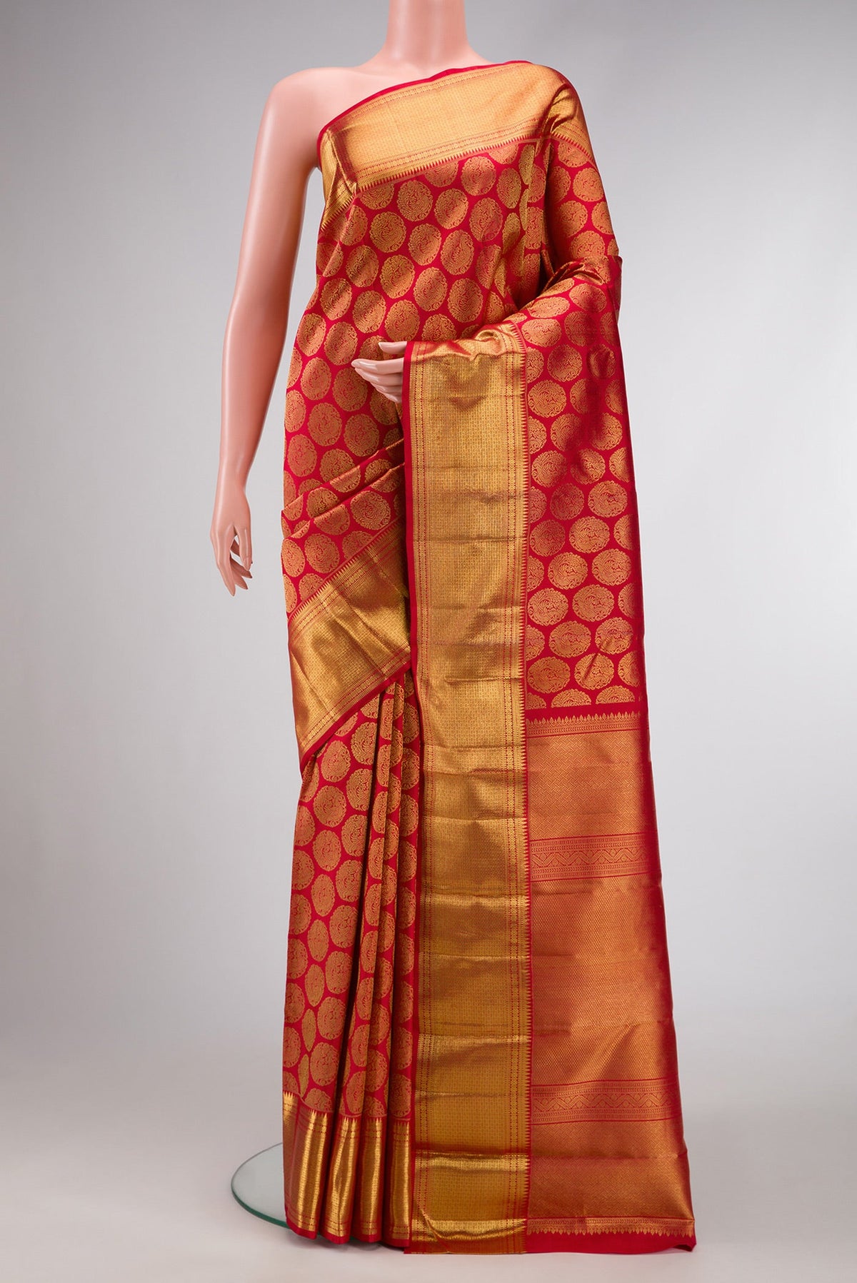 Pure Silk Pure Zari Red Dual Tone Kanjivaram Saree with Zari Brocade on the body and Zari Border.  displayed on a mannequin