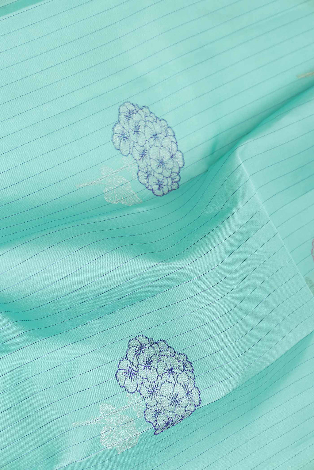 Close up of Pure Silk Pure Zari Sea Green Dual Tone Kanchipuram Saree with Zari Butta on the body and Without Border displaying folds