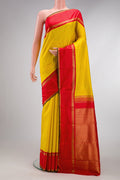 Yellow Dual Tone Kanjivaram Silk Saree with Zari Butta on the body and Zari Border.  displayed on a mannequin