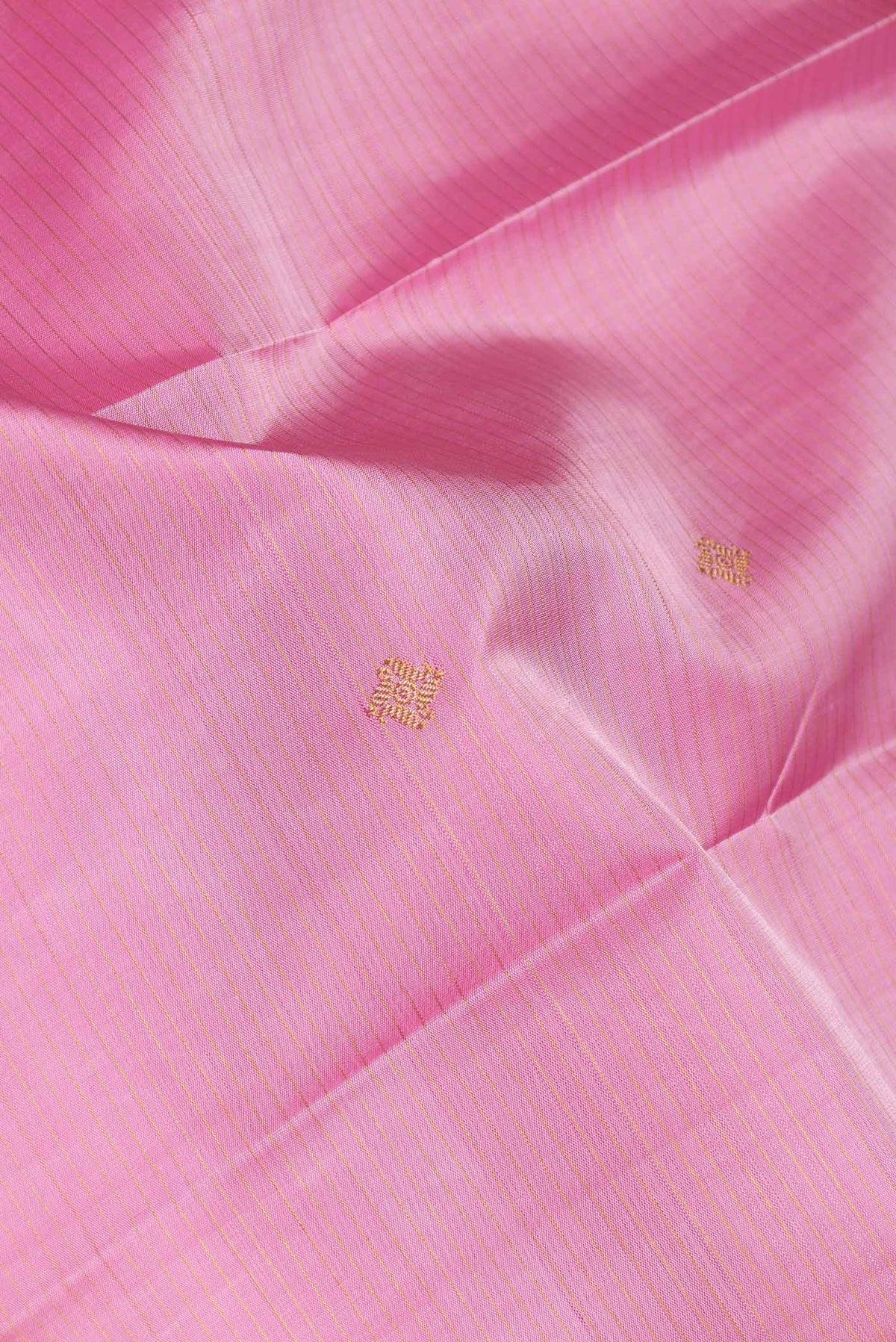 Close up of Pure Silk Pure Zari Pink Dual Tone Kanchipuram Saree with Zari Butta on the body and Zari Border displaying folds
