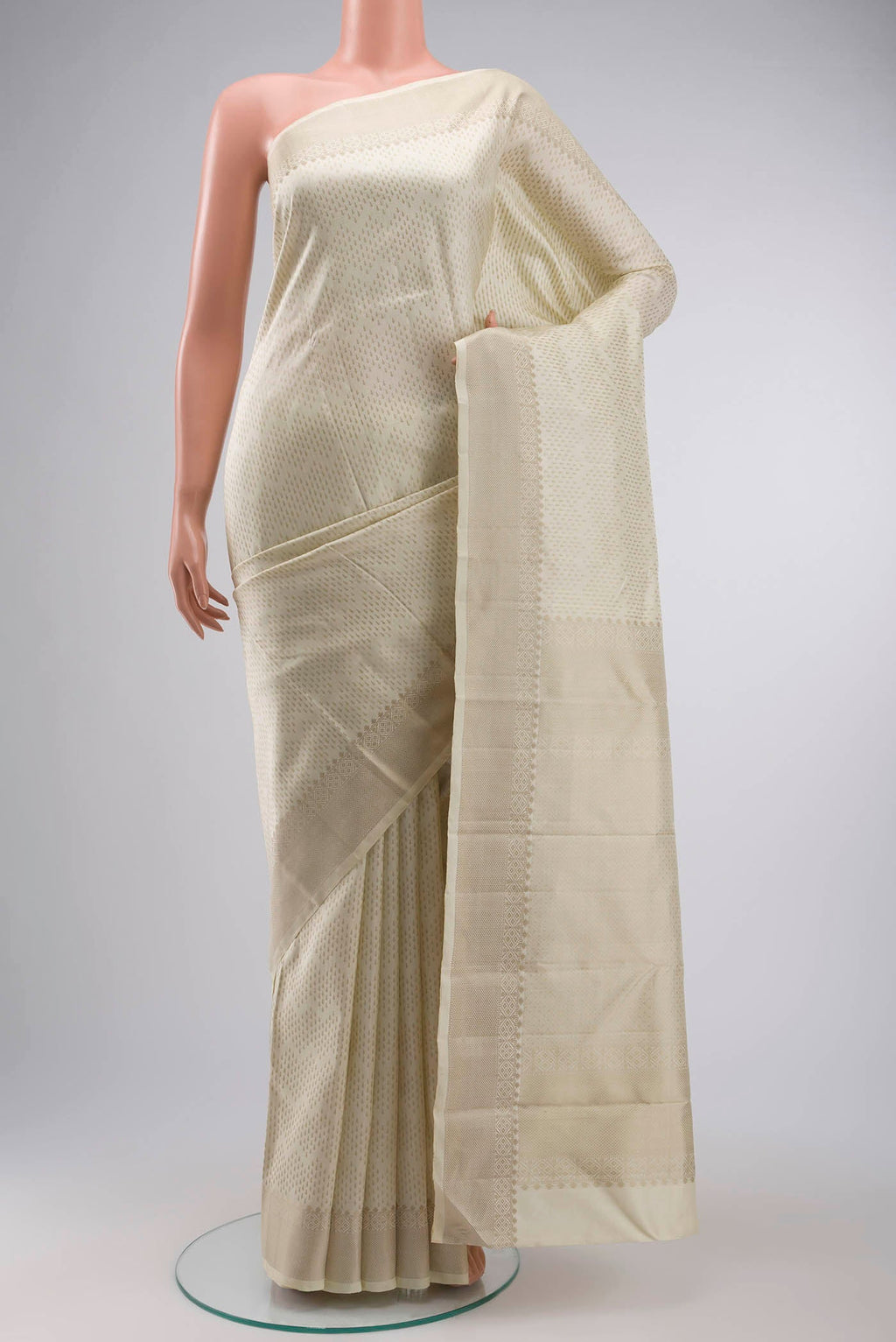 Cream Kanchipuram Silk Saree with Thread Butta on the body and Thread Border displayed on a mannequin