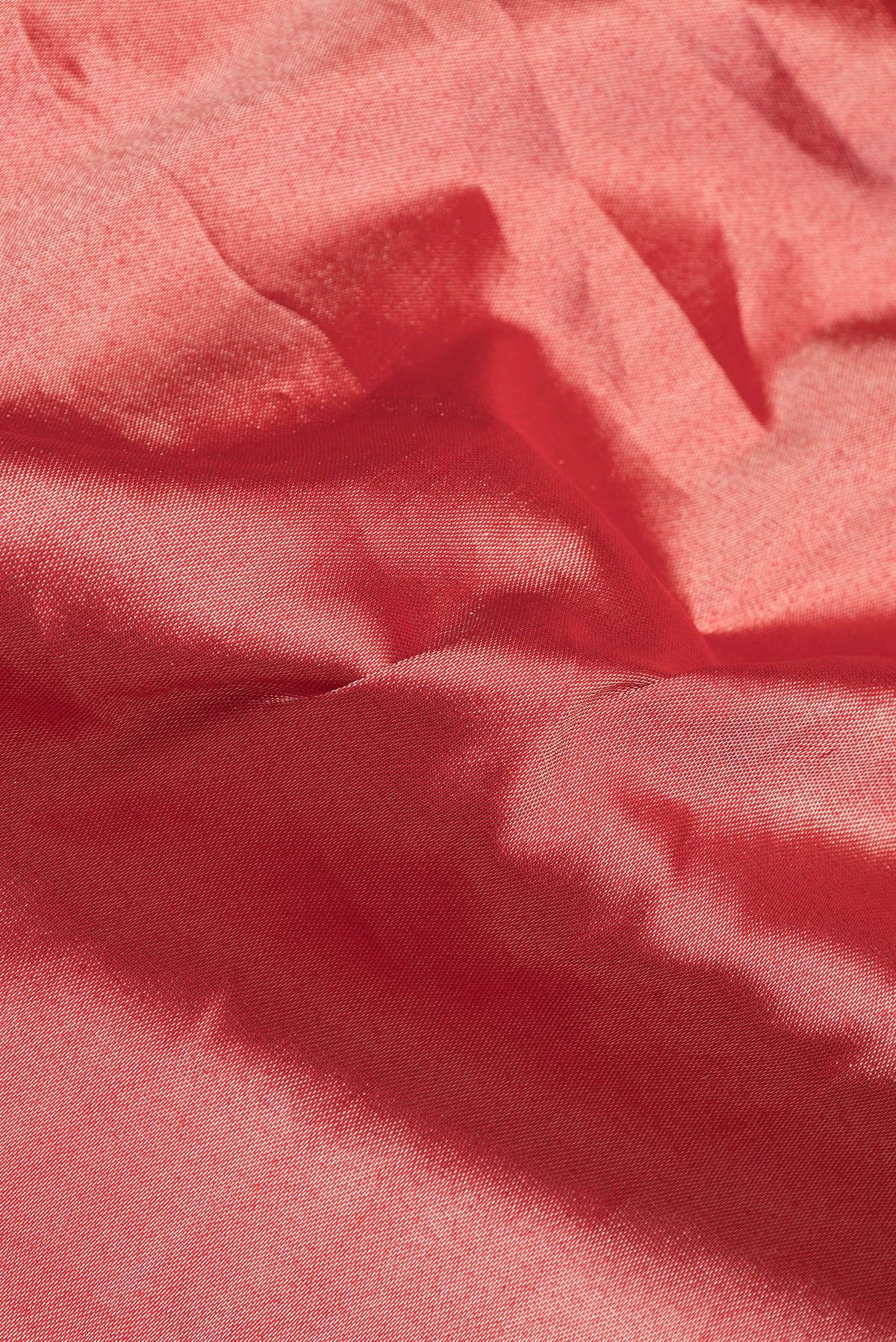 Close up of Red Dual Tone Banarasi Silk Saree with Zari Brocade on the body and Zari Border.  displaying folds