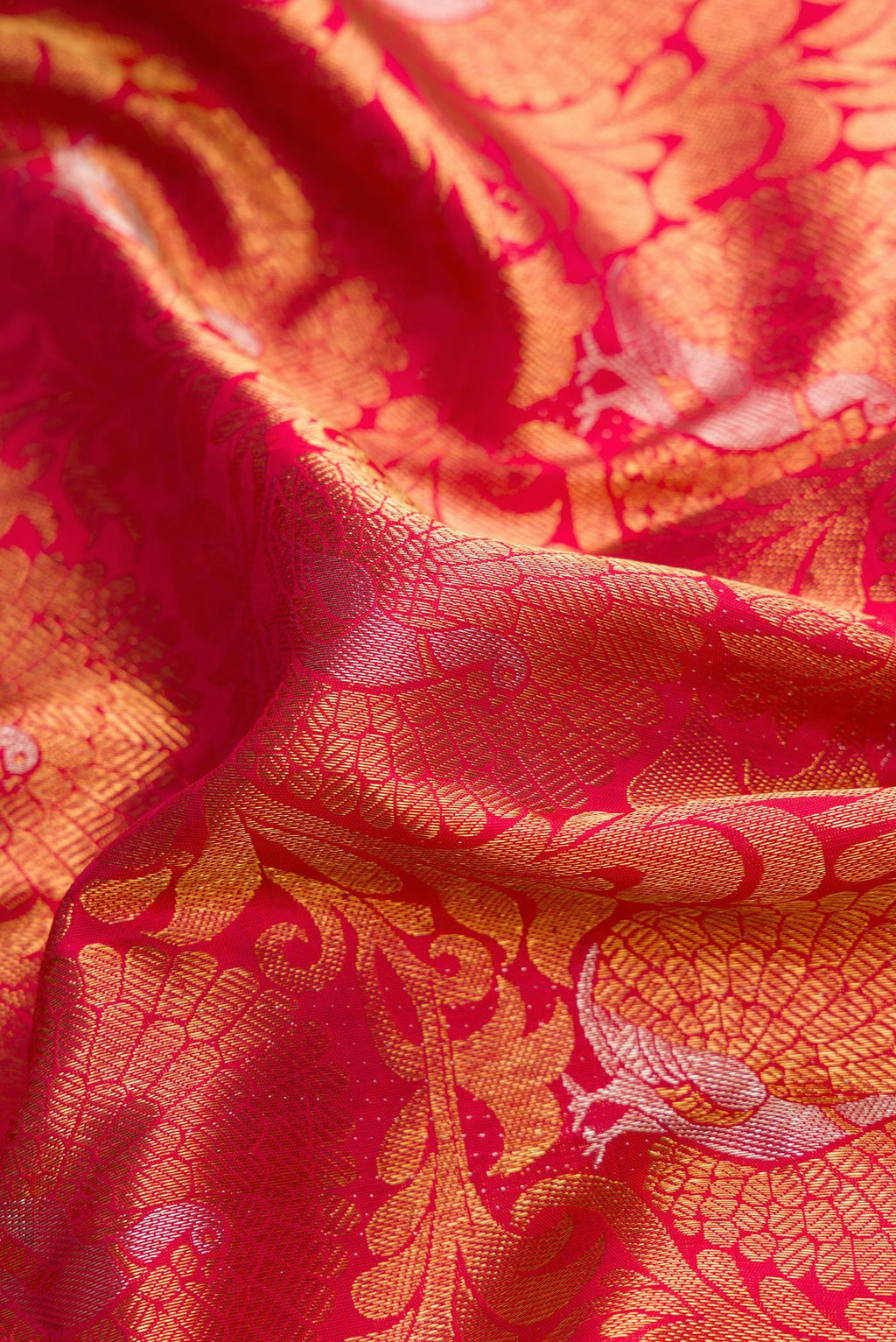 Close up of Pure Silk Pure Zari Dark Pink Dual Tone Kanjivaram Saree with Zari Brocade on the body and Zari Border.  displaying folds