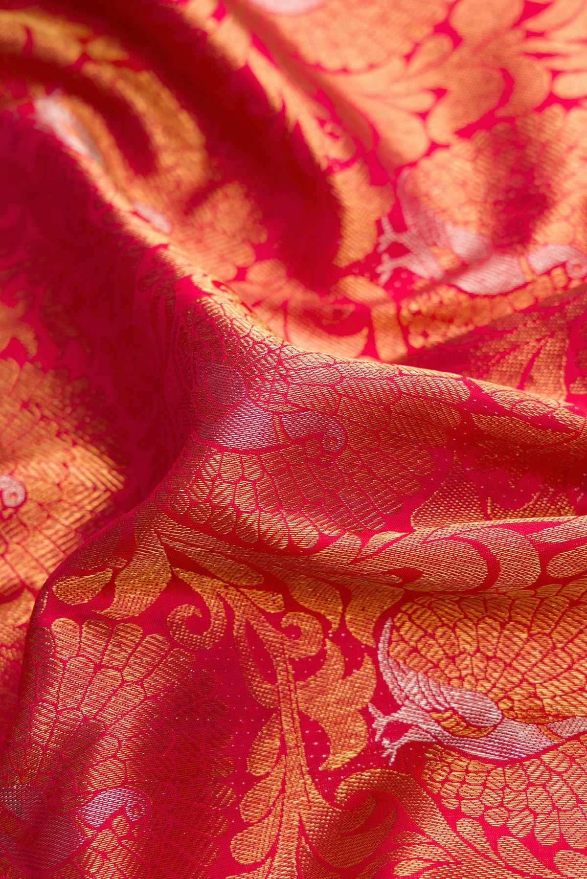 Close up of Pure Silk Pure Zari Dark Pink Dual Tone Kanjivaram Saree with Zari Brocade on the body and Zari Border.  displaying folds