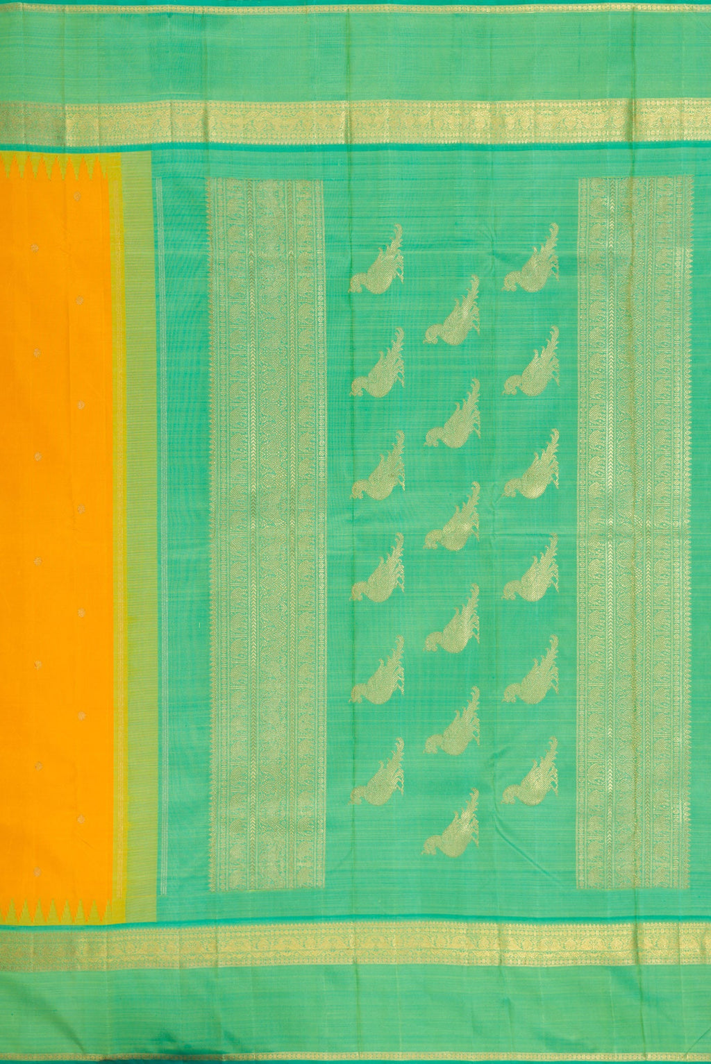 Close up image of the pallu of Yellow Kanchipuram Silk Saree with Zari Butta on the body and Zari Border. 
