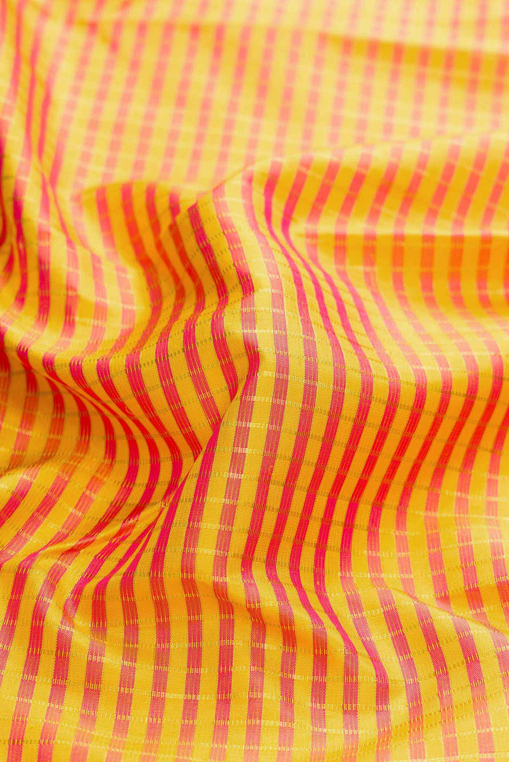 Close up of Yellow Dual Tone Kanchipuram Silk Saree with Checked design on the body and Fancy Border displaying folds