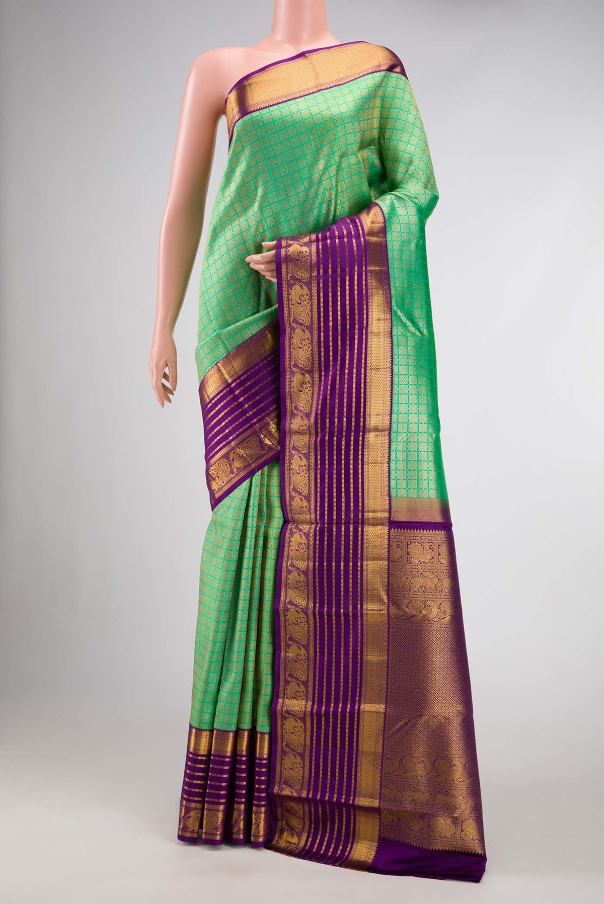 Green Dual Tone Kanjivaram Silk Saree with Zari Brocade on the body and Zari Border.  displayed on a mannequin