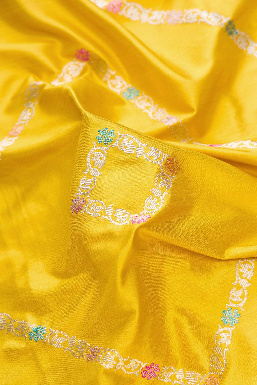 Close up of Mehandi Green Dual Tone Banarasi Silk Saree with Zari Butta on the body and Zari Border.  displaying folds