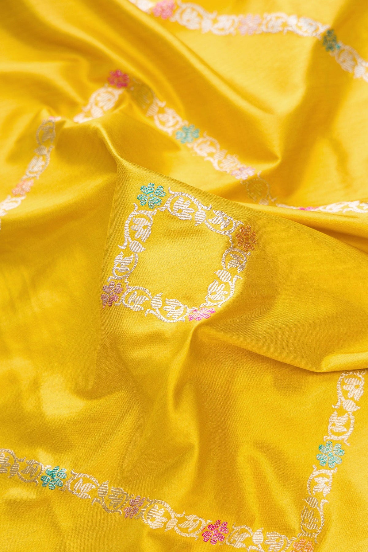 Close up of Mehandi Green Dual Tone Banarasi Silk Saree with Zari Butta on the body and Zari Border.  displaying folds