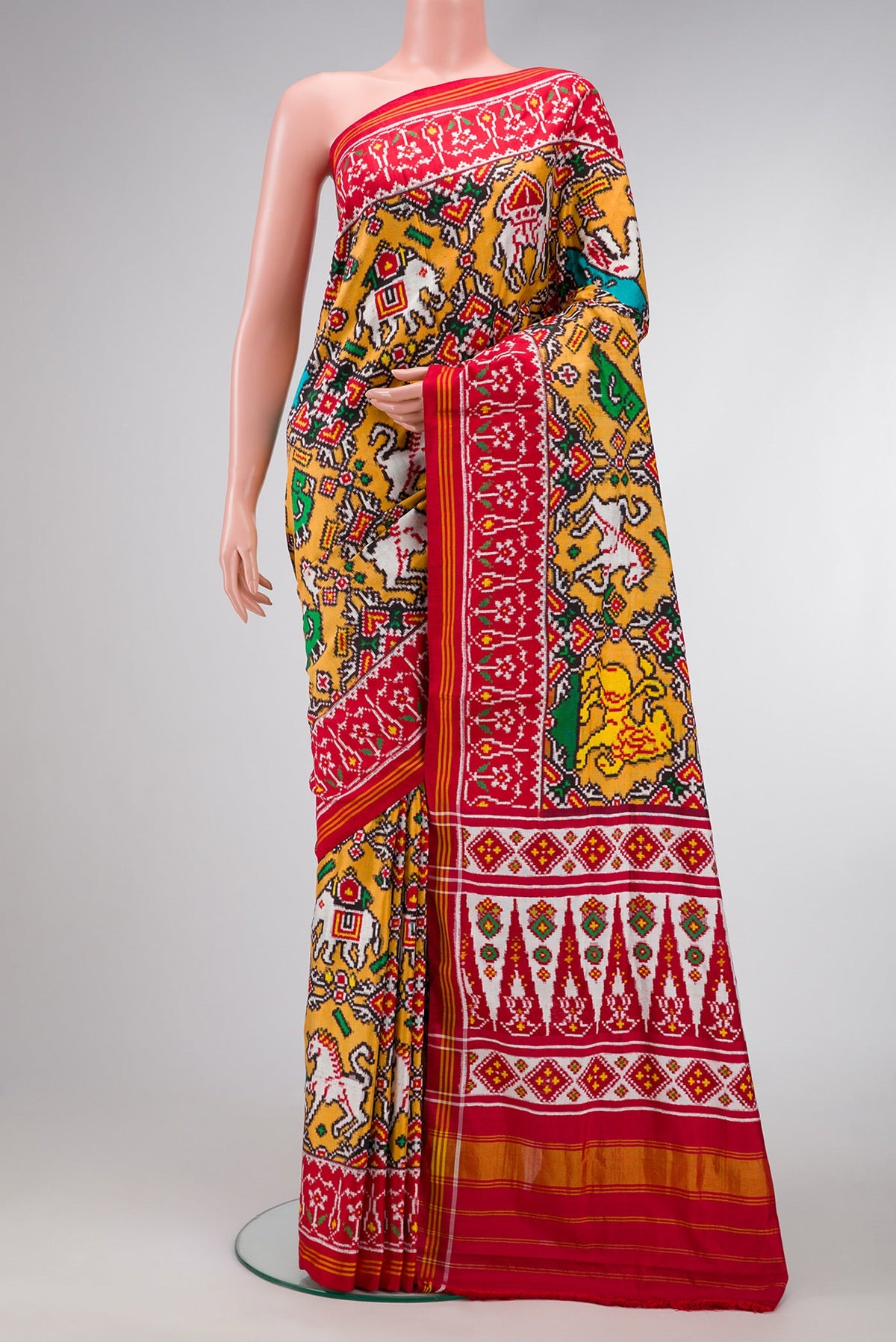 Mustard Dual Tone Double Ikat Saree with Ikat Print on the body and Ikat Border.  displayed on a mannequin