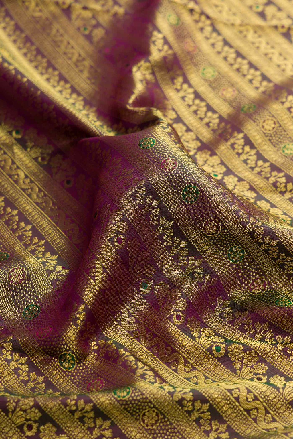 Close up of Burgundy Dual Tone Kanchipuram Silk Saree with Zari Brocade on the body and Zari Border displaying folds
