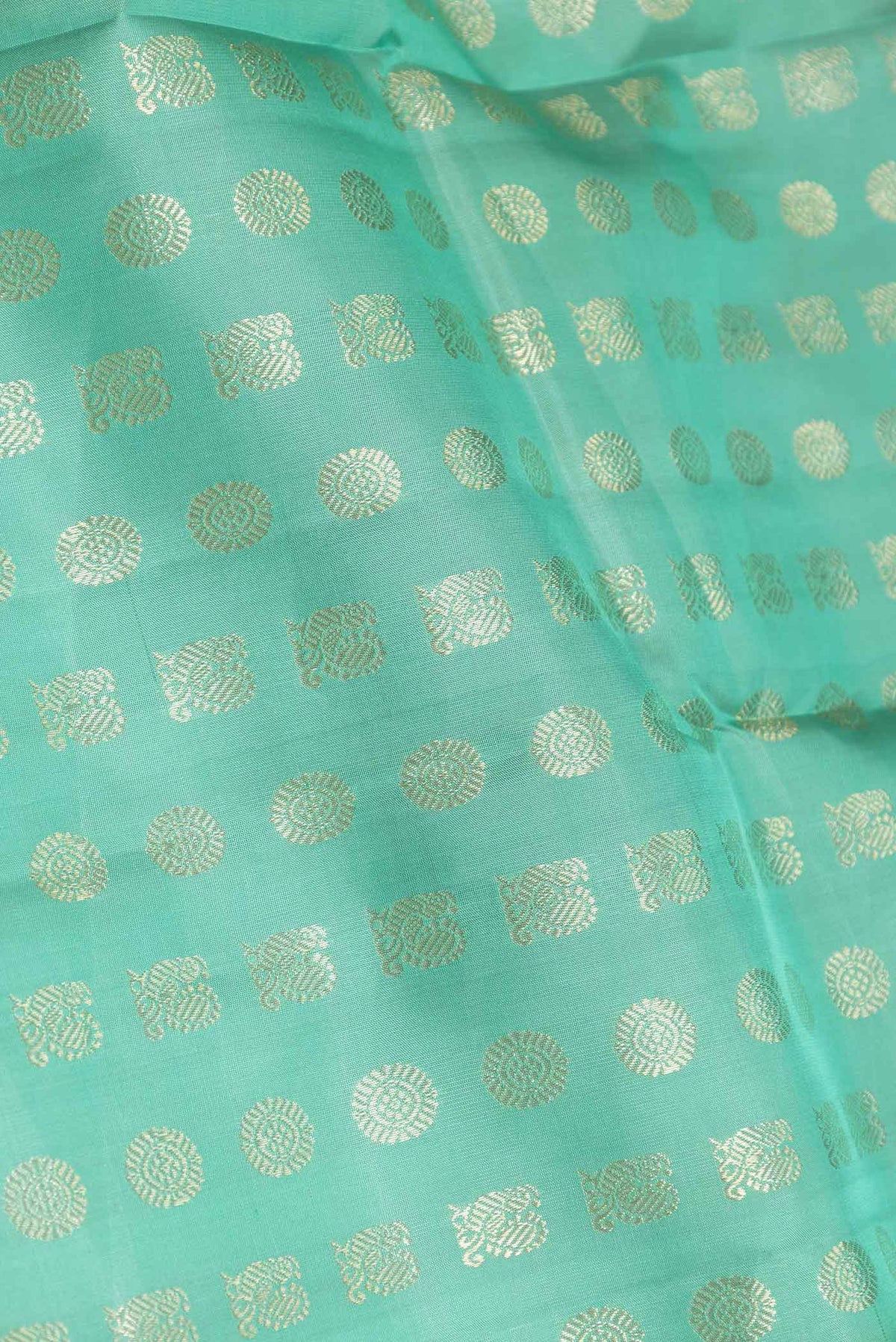 Close up of Sea Green Dual Tone Kanchipuram Saree with Zari Butta on the body and Zari Border displaying folds