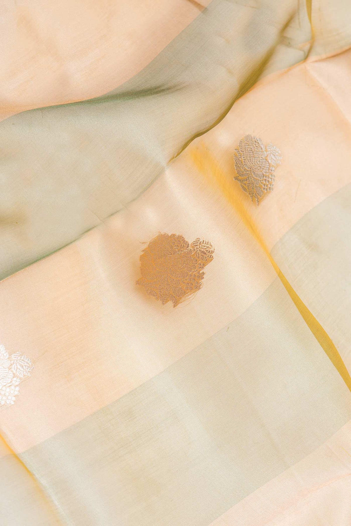 Close up of Green Dual Tone Organza Silk Saree with Stripes on the body and Without Border displaying folds