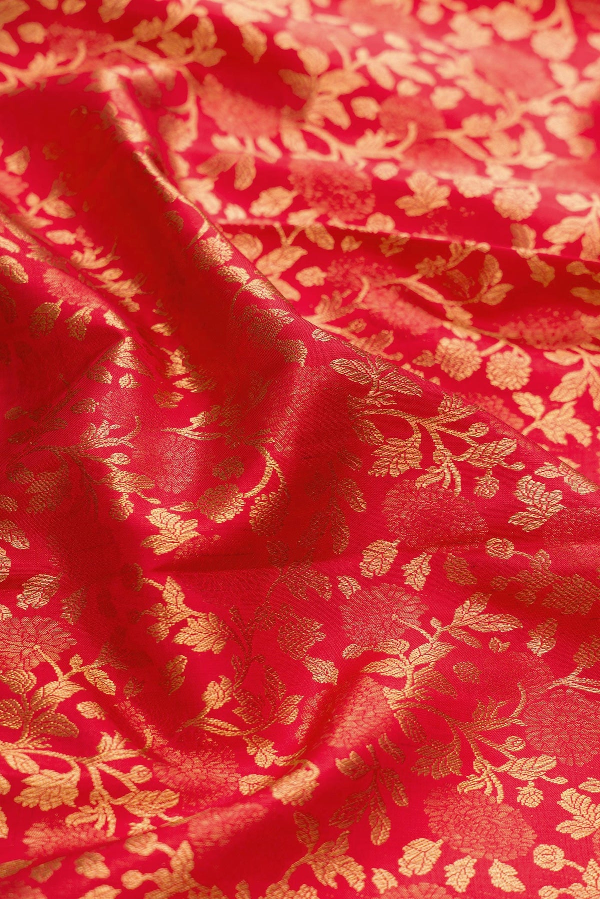 Close up of Red Dual Tone Kanchipuram Silk Saree with Zari Brocade on the body and Zari Border.  displaying folds