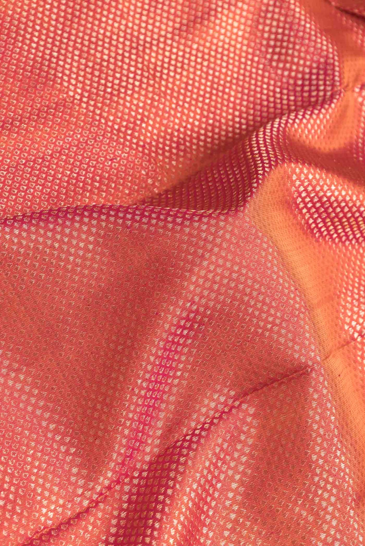 Close up of Pink Dual Tone Kanchipuram Silk Saree with Zari Brocade on the body and Zari Border displaying folds