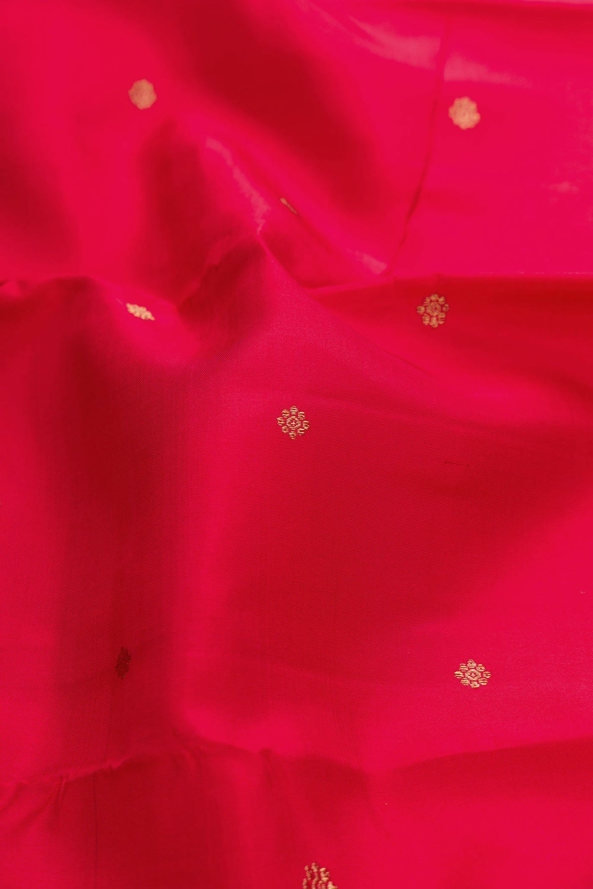 Close up of Pure Silk Pure Zari Pink Kanchipuram Saree with Zari Butta on the body and Zari Border displaying folds