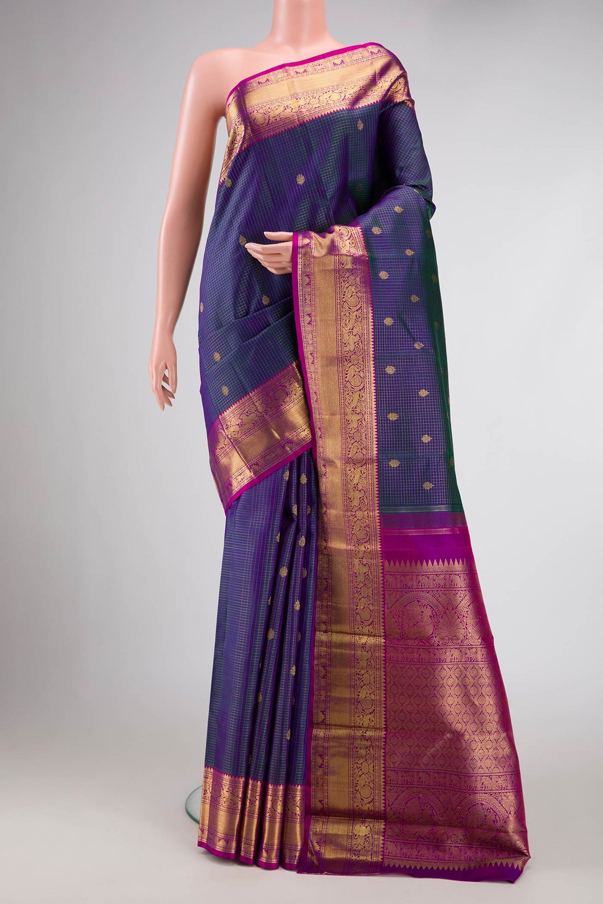 Pure Silk Pure Zari Peacock Blue Dual Tone Kanchipuram Saree with Checked design on the body and Zari Border displayed on a mannequin