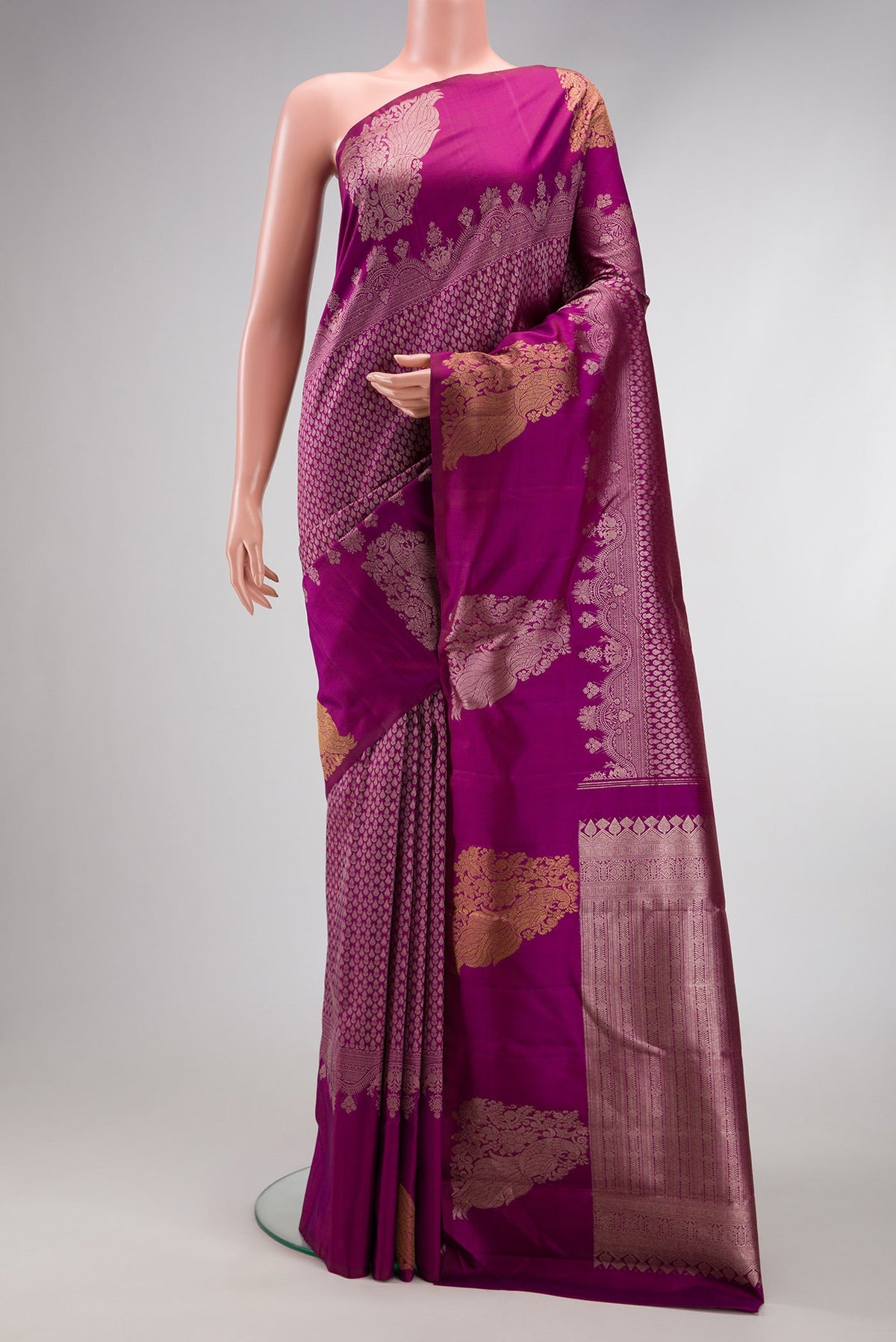 Magenta Kanchipuram Silk Saree with Zari Brocade on the body and Fancy Border.  displayed on a mannequin