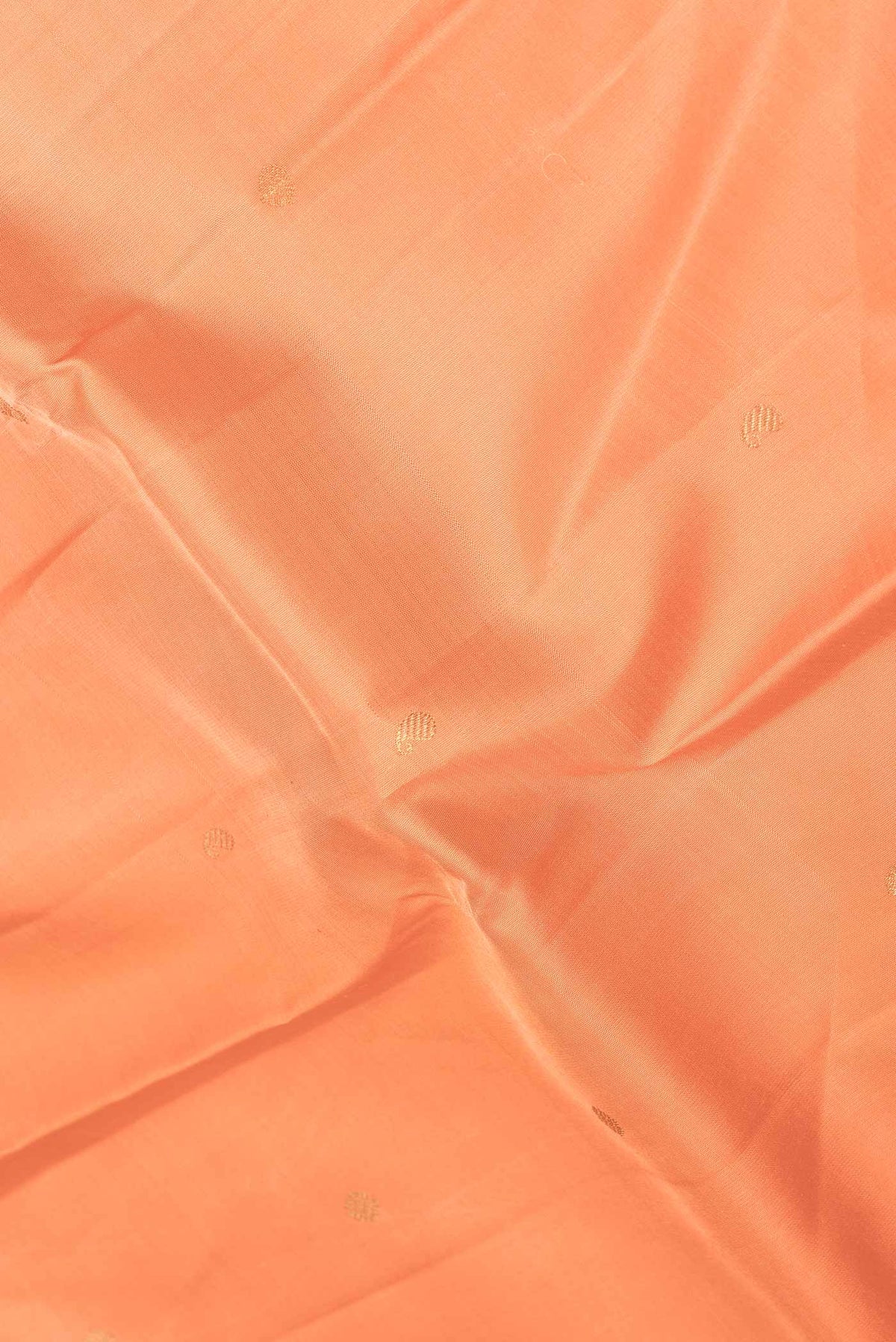 Close up of Orange Dual Tone Kanchipuram Silk Saree with Stripes on the body and Zari Border displaying folds