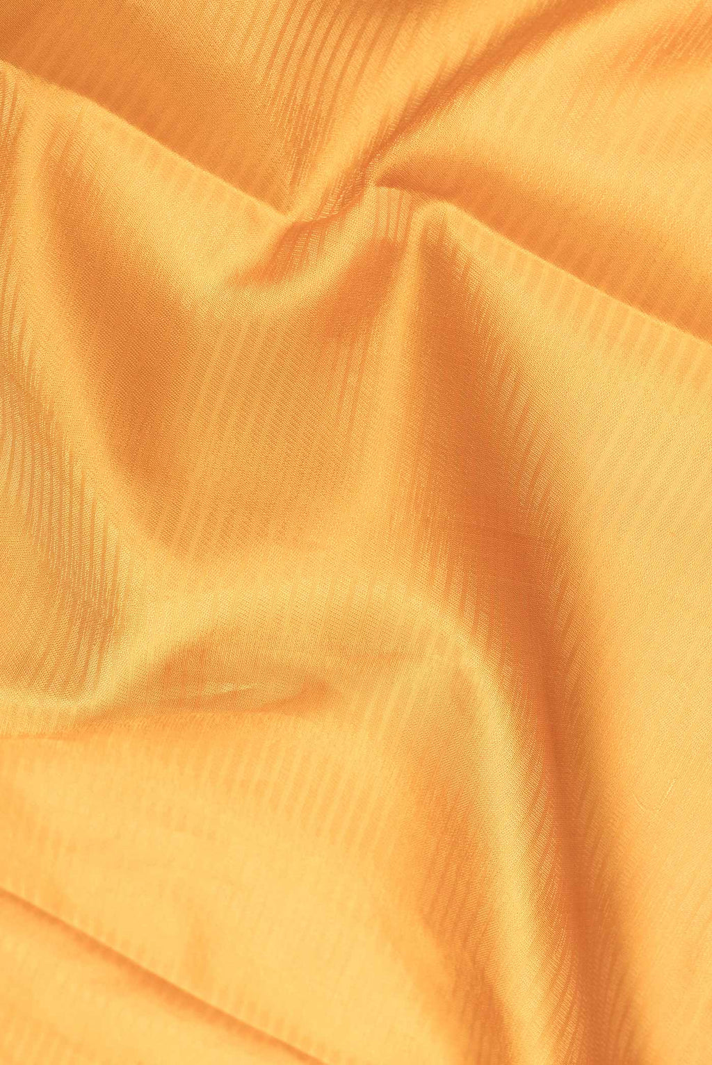 Close up of Mustard Dual Tone Soft Silk Saree with Zari Brocade on the body and Zari Border.  displaying folds