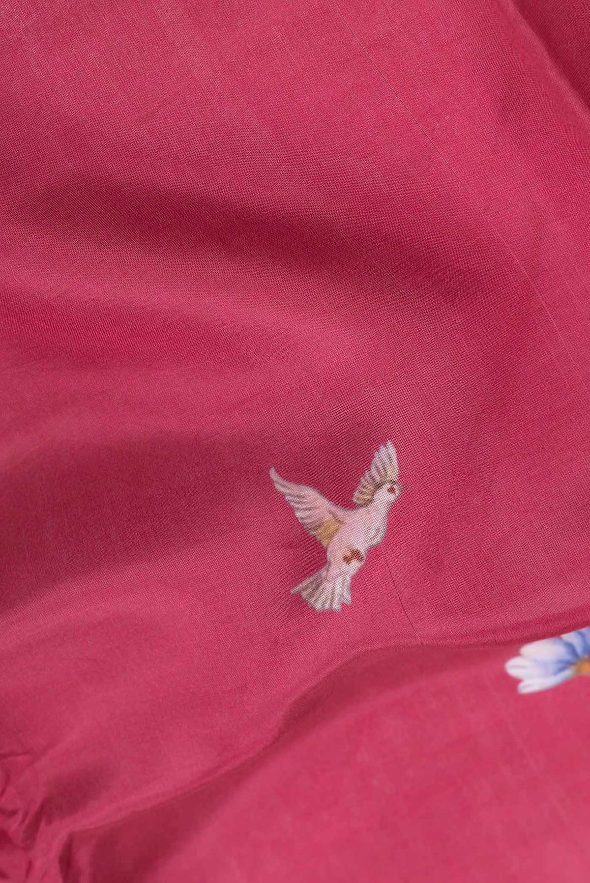 Close up of Maroon Dual Tone Tussar Silk SareePrinted design on the body and Zari Border displaying folds