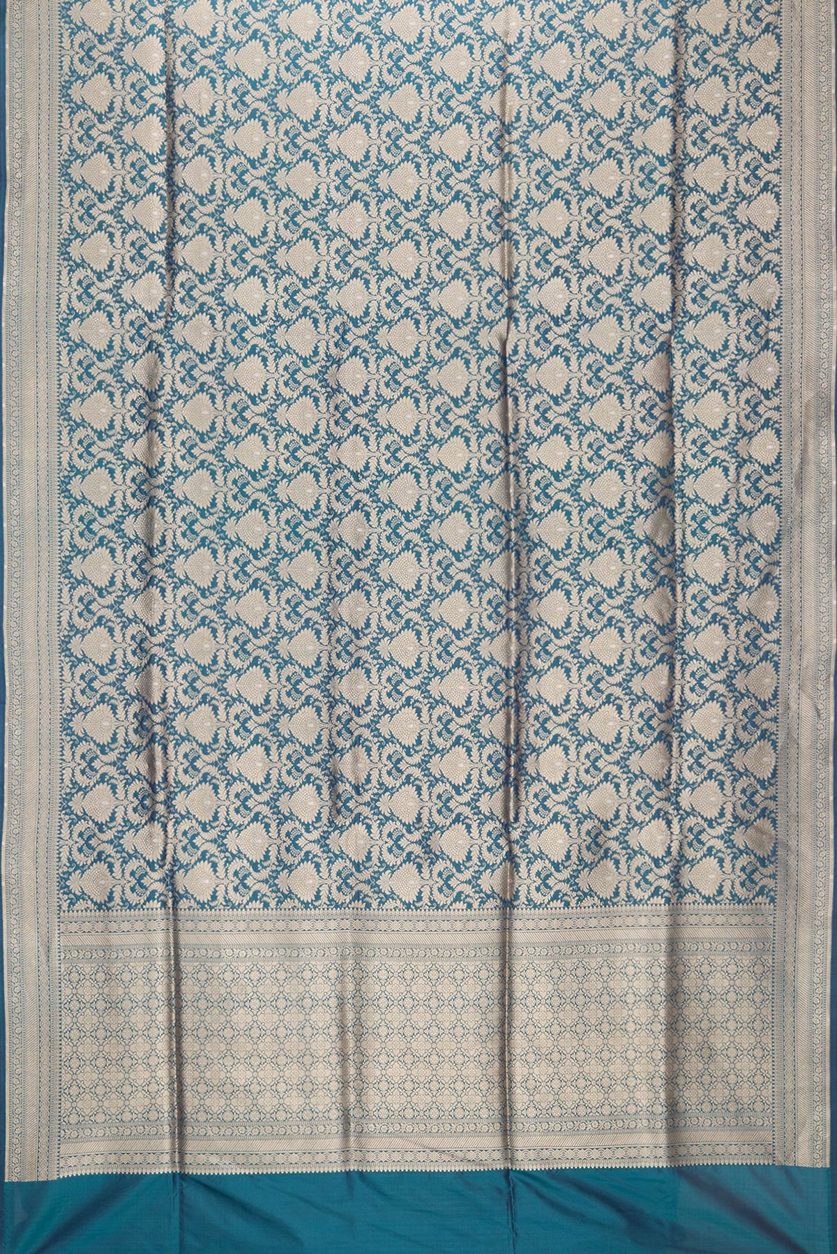 Flat view of Peacock Blue Dual Tone Banarasi Silk Saree with Zari Brocade on the body and Zari Border. 