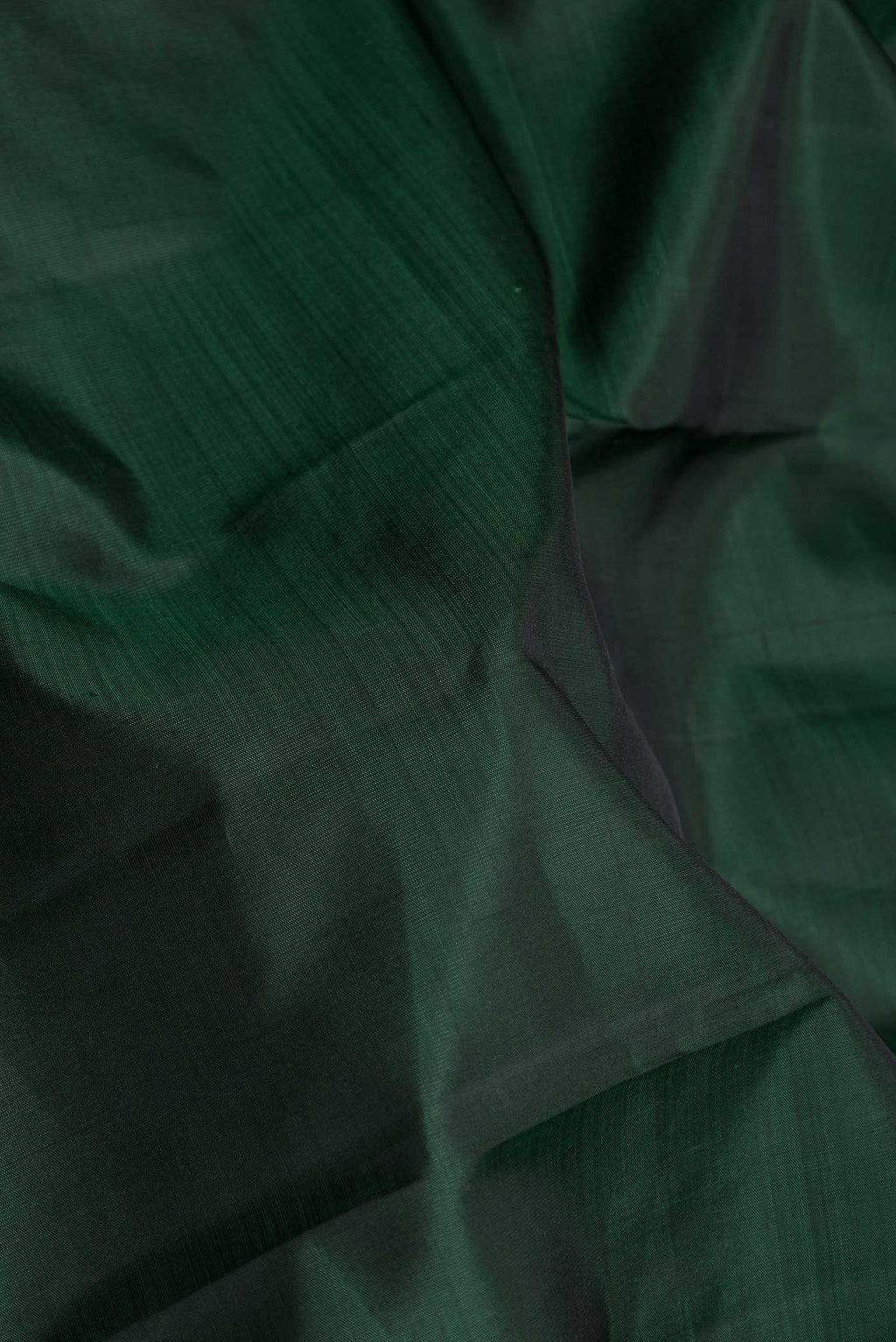Close up of Pure Silk Pure Zari Green Dual Tone Kanchipuram Saree with Plain Body and Zari Border displaying folds