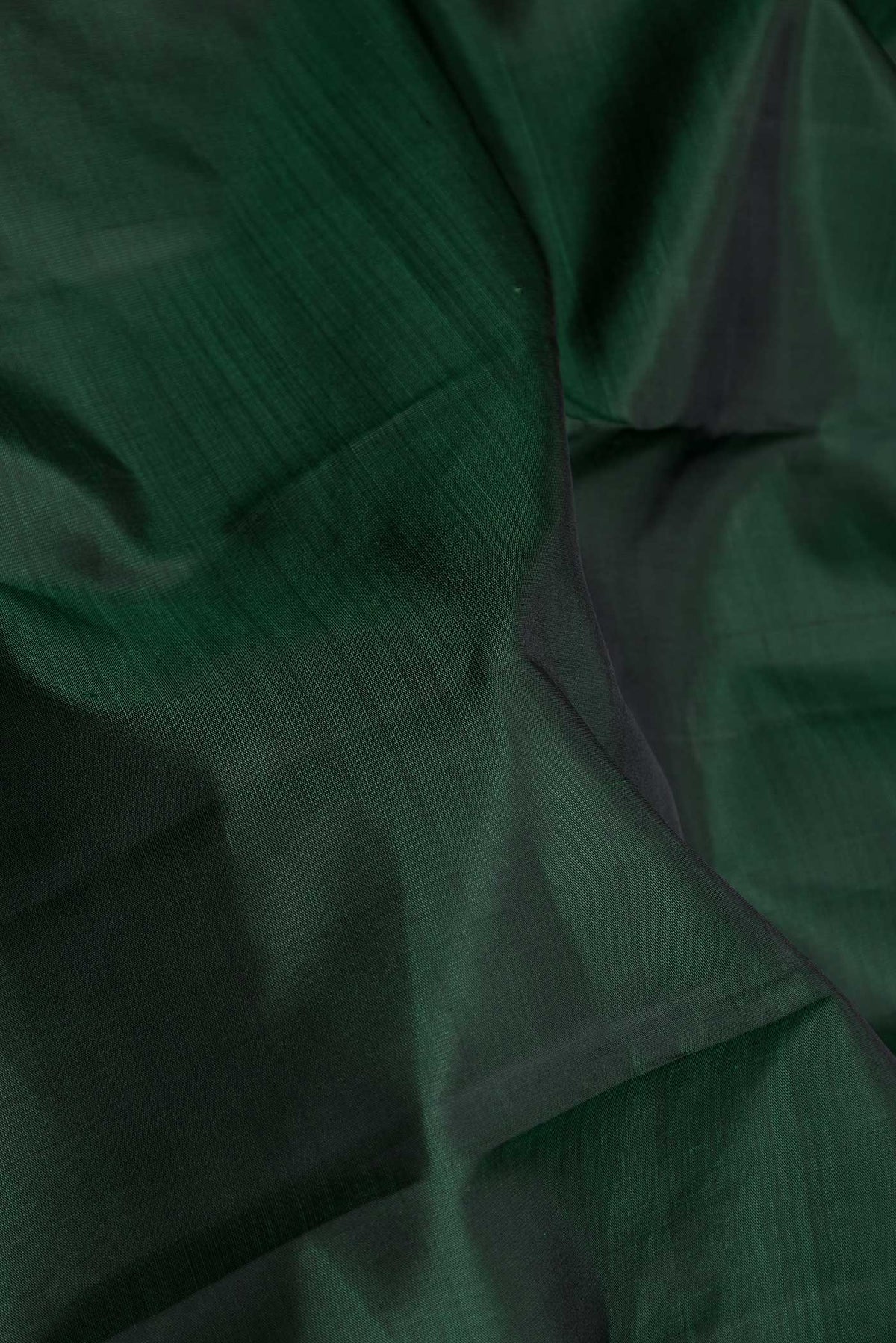 Close up of Pure Silk Pure Zari Green Dual Tone Kanchipuram Saree with Plain Body and Zari Border displaying folds