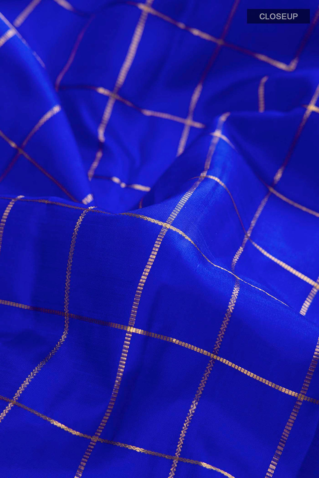 Close up of Blue Kanchipuram Silk Saree with Checked design on the body and Zari Border displaying folds