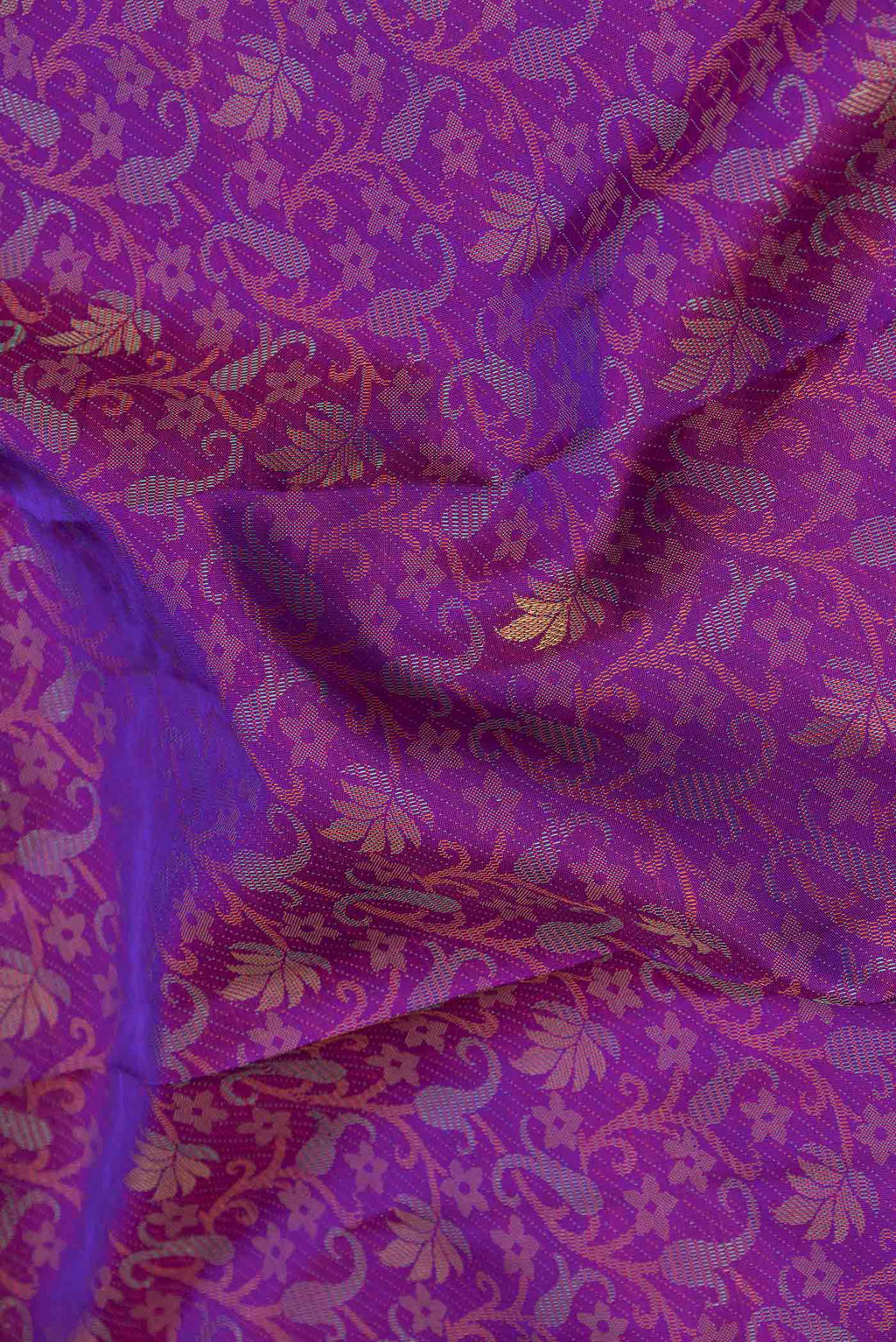 Close up of Pure Silk Pure Zari Purple Dual Tone Kanchipuram Saree with Jacquard With Zari Butta on the body and Zari Border displaying folds