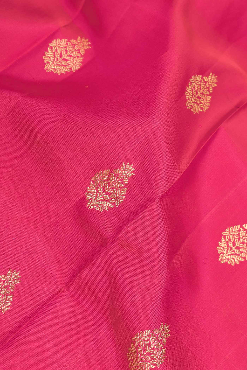 Close up of Dark Pink Dual Tone Kanchipuram Silk Saree with Zari Butta on the body and Zari Border displaying folds