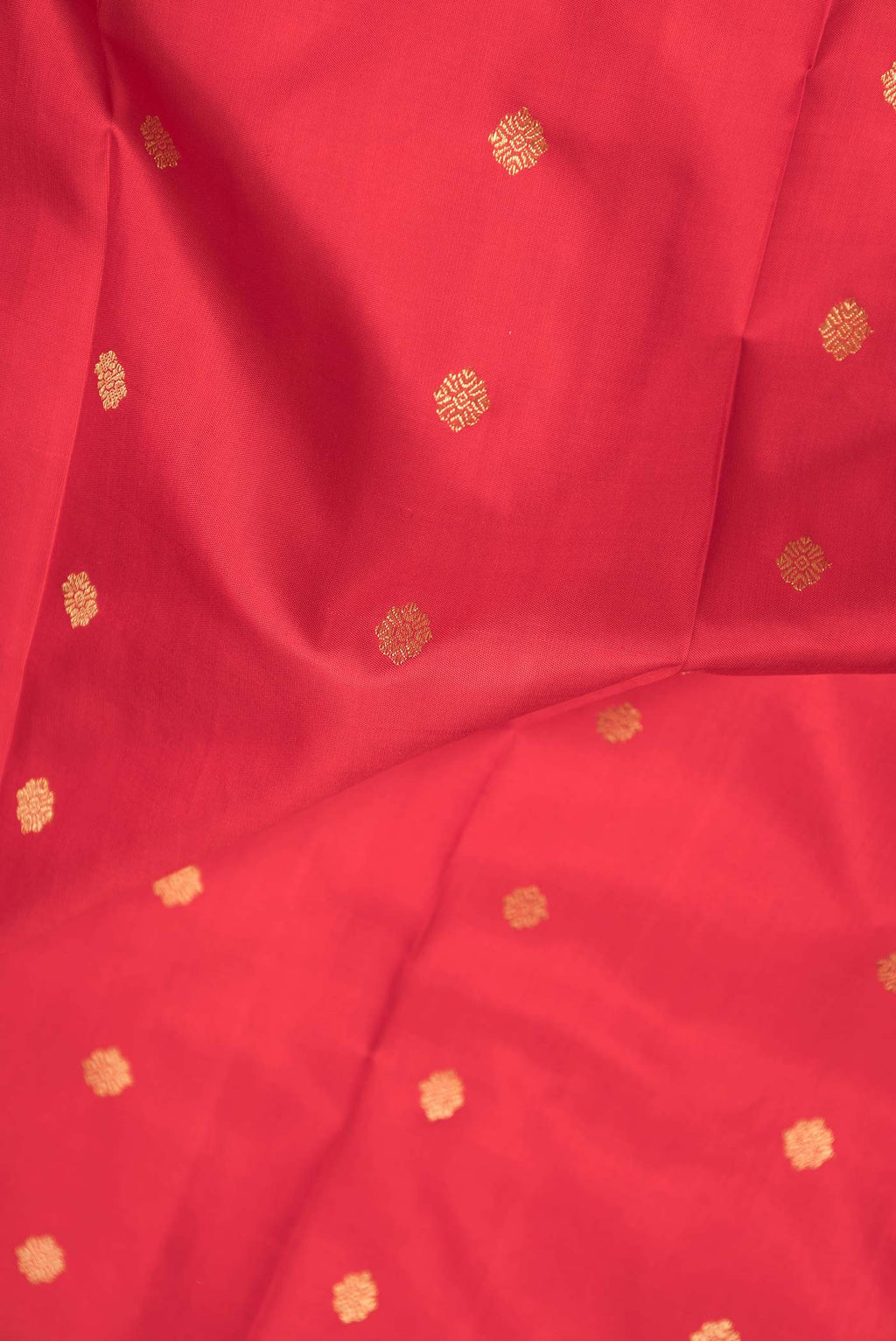 Close up of Pure Silk Pure Zari Red Dual Tone Kanchipuram Saree with Zari Butta on the body and Zari Border displaying folds