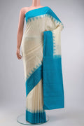 Cream Kanchipuram Silk Saree with Plain Body and Temple Border displayed on a mannequin